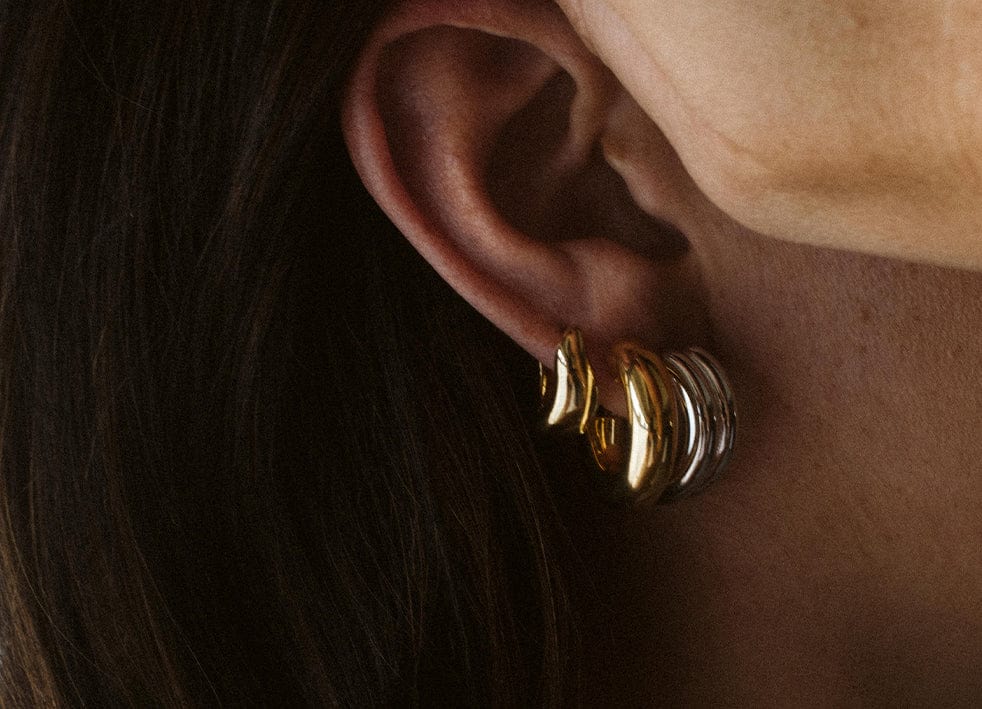 Statement earrings in yellow and silver gold. Bold jewelry for everyone.